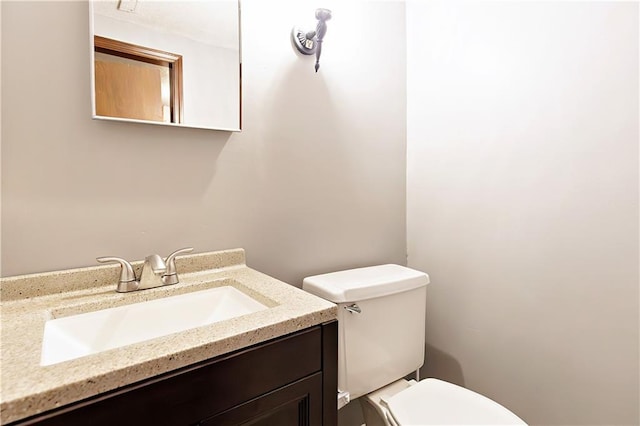 bathroom featuring toilet and vanity