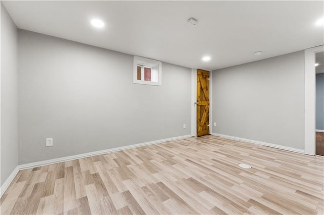 basement with light hardwood / wood-style flooring