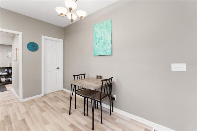 dining room with a chandelier and light hardwood / wood-style floors