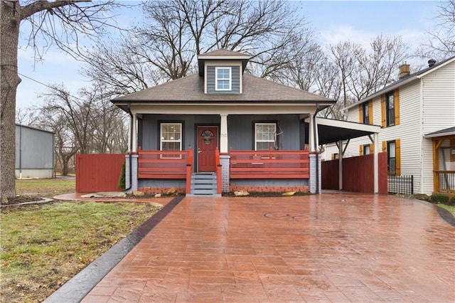 bungalow-style home featuring a carport and covered porch