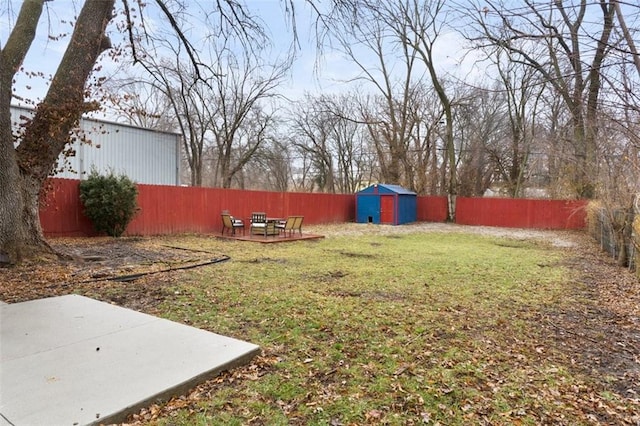 view of yard featuring a patio and a storage shed