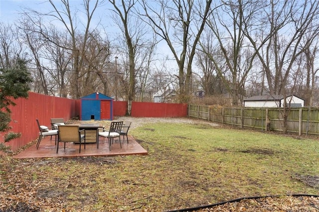 view of yard with a deck and a storage unit