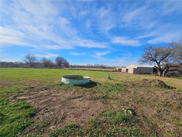 view of yard featuring an outbuilding and a rural view