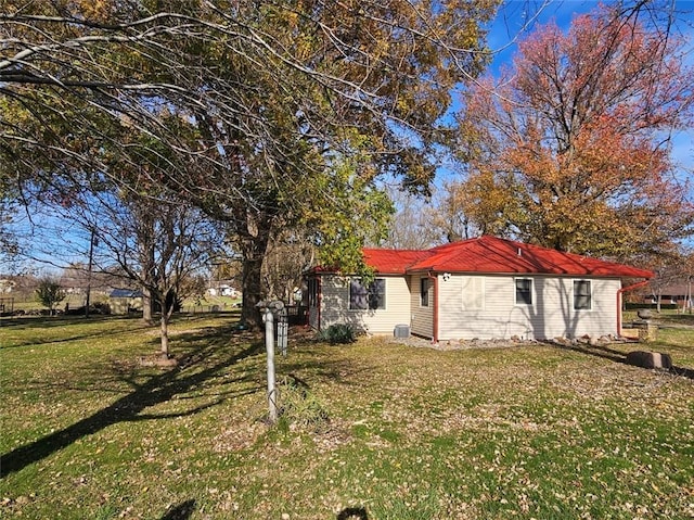 view of property exterior with a lawn