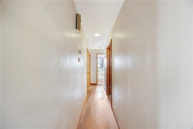 corridor featuring light wood-style flooring