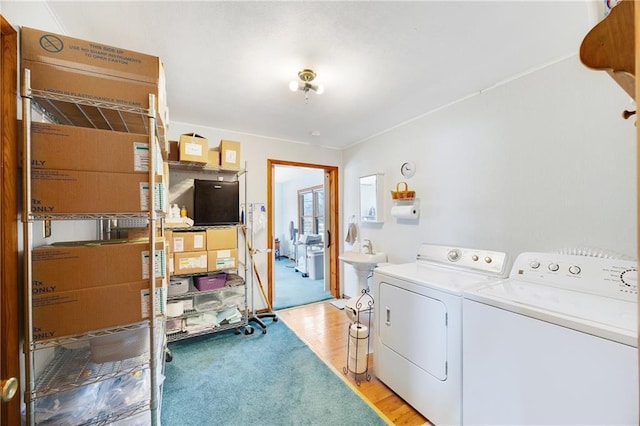 laundry area with light wood-style flooring and washer and dryer