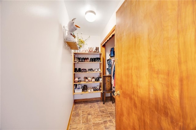 interior space with baseboards and stone finish flooring