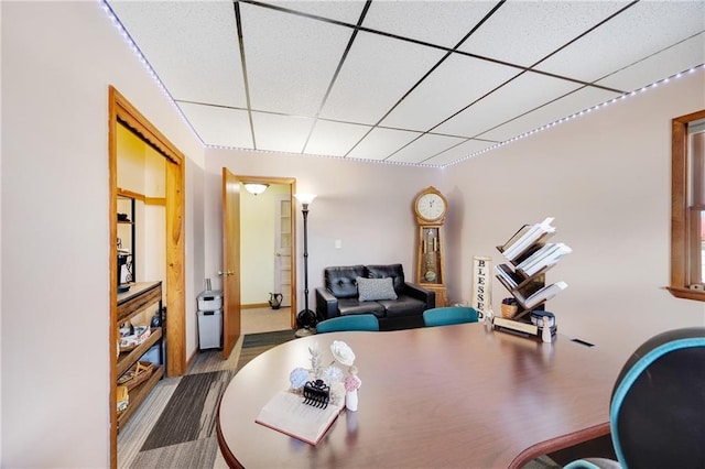 office area with a paneled ceiling