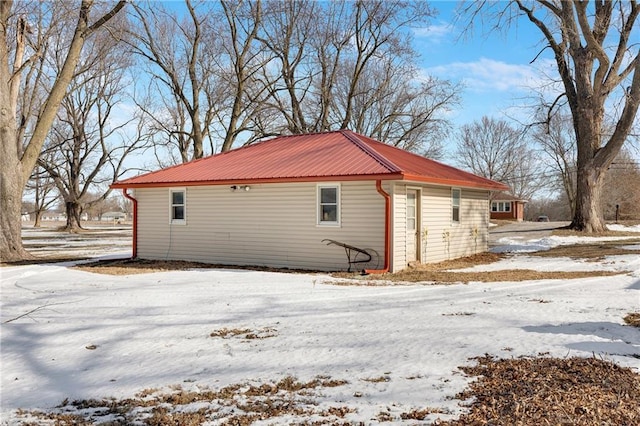 view of snow covered exterior featuring metal roof