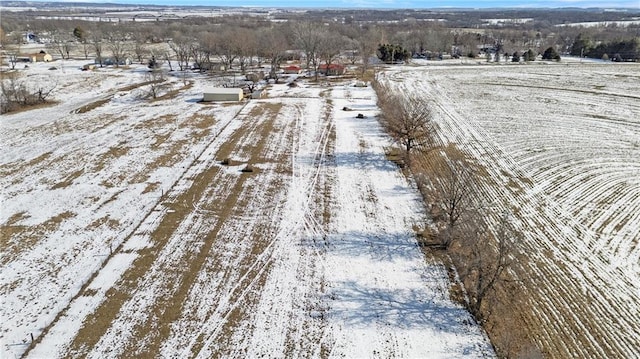 snowy aerial view featuring a rural view