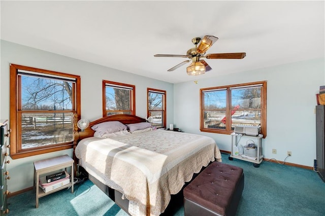 carpeted bedroom with a ceiling fan and baseboards