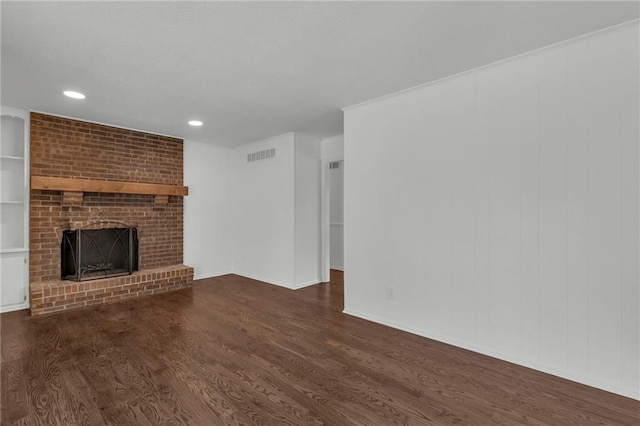 unfurnished living room with dark hardwood / wood-style flooring and a fireplace