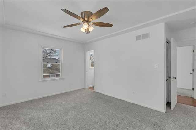 empty room with ceiling fan and carpet