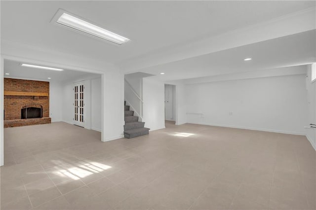 basement featuring light tile patterned flooring and a fireplace