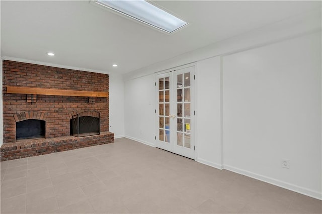 unfurnished living room with french doors and a brick fireplace