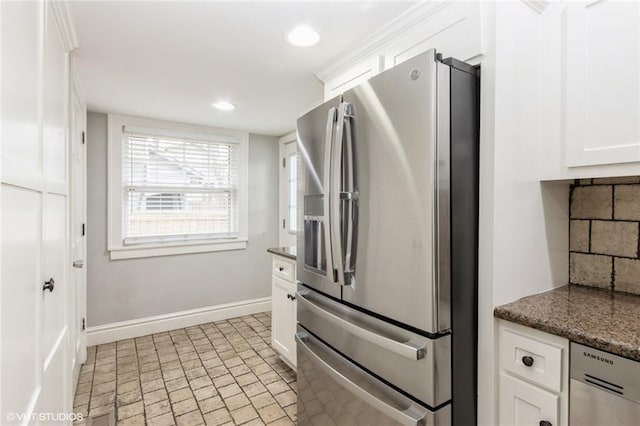 kitchen featuring recessed lighting, white cabinetry, baseboards, appliances with stainless steel finishes, and backsplash