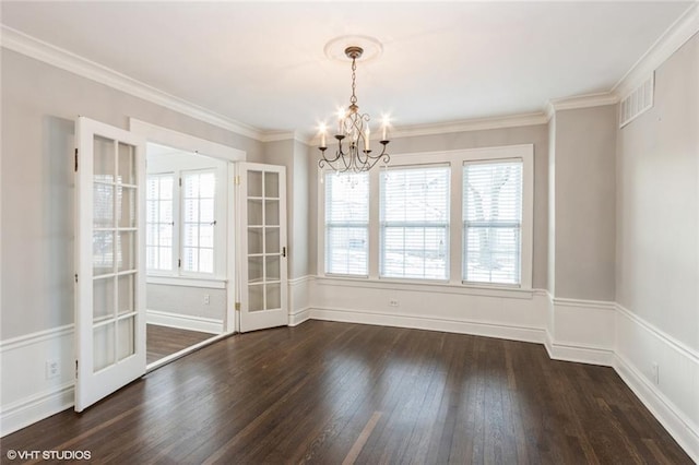 unfurnished dining area with ornamental molding, dark wood-style flooring, visible vents, and a chandelier