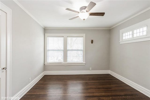 spare room with ornamental molding, dark wood-style flooring, ceiling fan, and baseboards