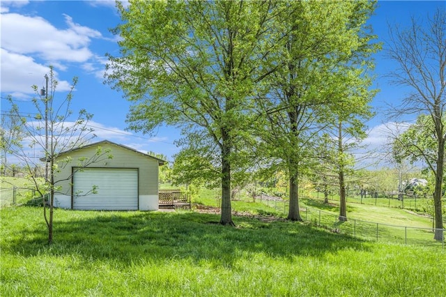 10609 NW Meadow Lane Dr, Parkville, MO 64152 - view of yard featuring a detached garage, fence, and an outbuilding