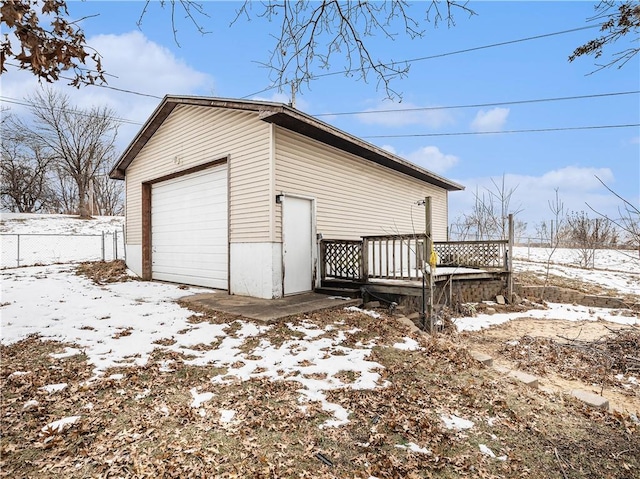 10609 NW Meadow Lane Dr, Parkville, MO 64152 - exterior space with fence, an outbuilding, a deck, and a detached garage
