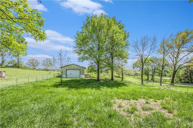 10609 NW Meadow Lane Dr, Parkville, MO 64152 - view of yard with a garage, fence, an outbuilding, and a rural view