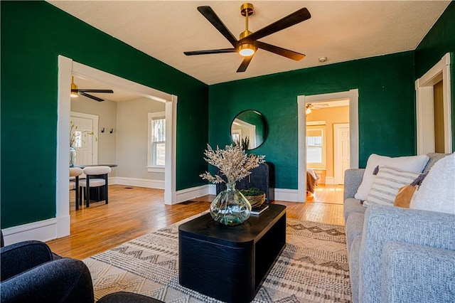 living area featuring wood finished floors and baseboards