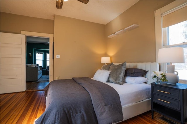 bedroom featuring ceiling fan and dark wood-type flooring