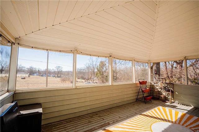 unfurnished sunroom featuring vaulted ceiling and wood ceiling