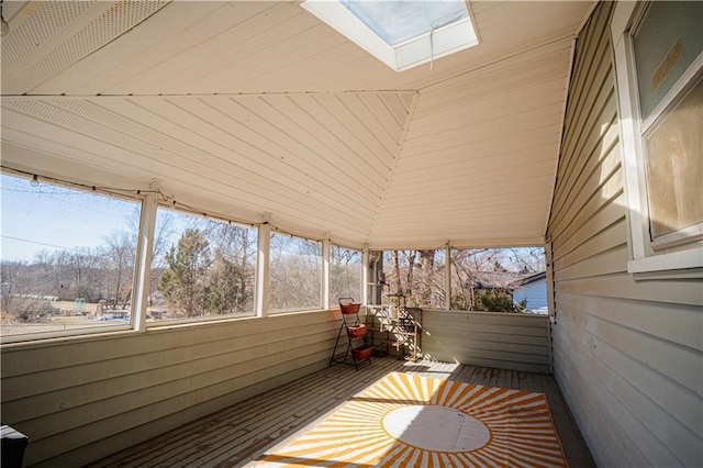 unfurnished sunroom with a skylight