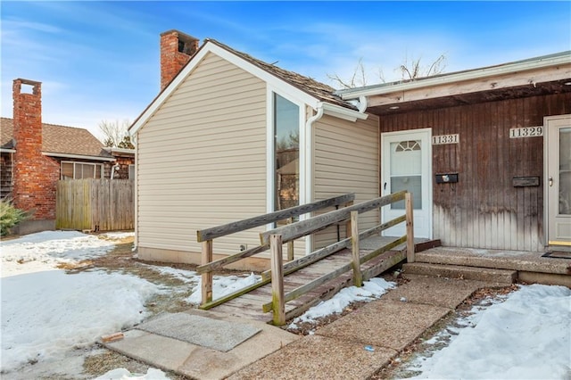 view of snow covered property entrance