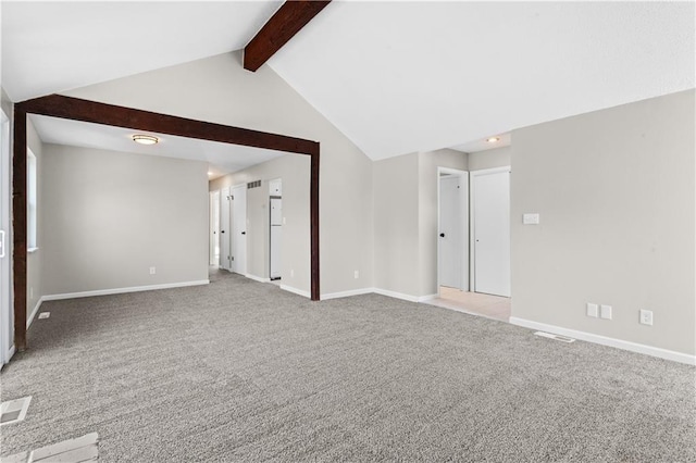 carpeted spare room with lofted ceiling with beams