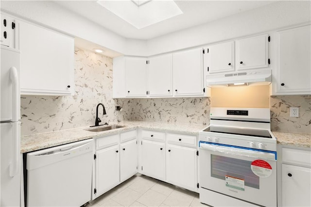 kitchen with sink, white cabinetry, a skylight, white appliances, and backsplash