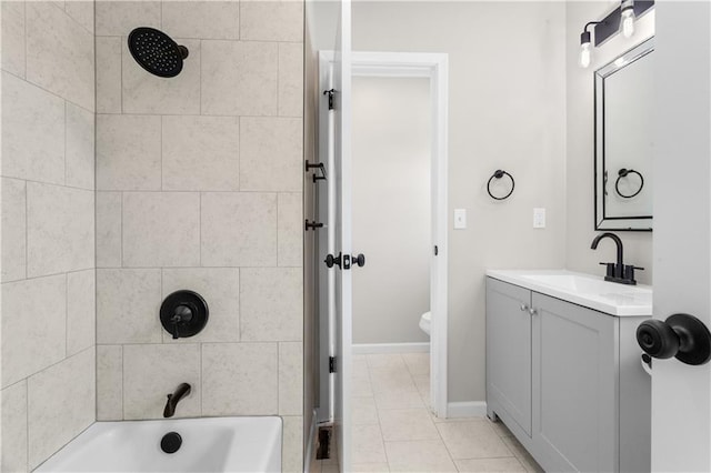 full bathroom with vanity, tile patterned flooring, tiled shower / bath combo, and toilet