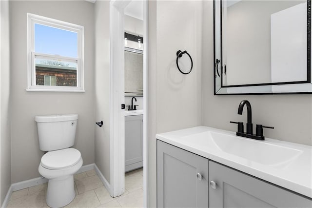 bathroom with vanity, tile patterned flooring, and toilet