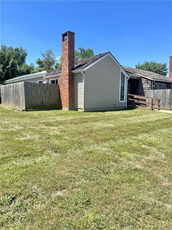 11331 Calico Dr, Kansas City, MO 64137 - back of house featuring a chimney