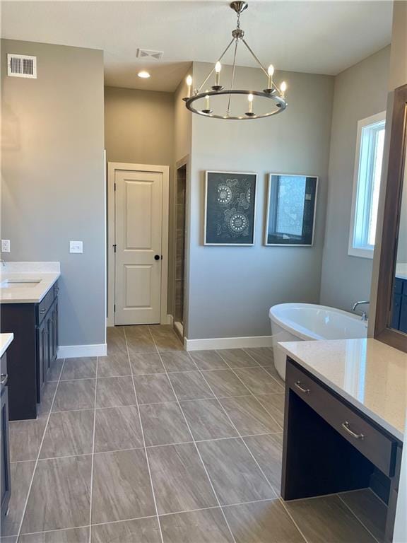 bathroom featuring vanity and a notable chandelier