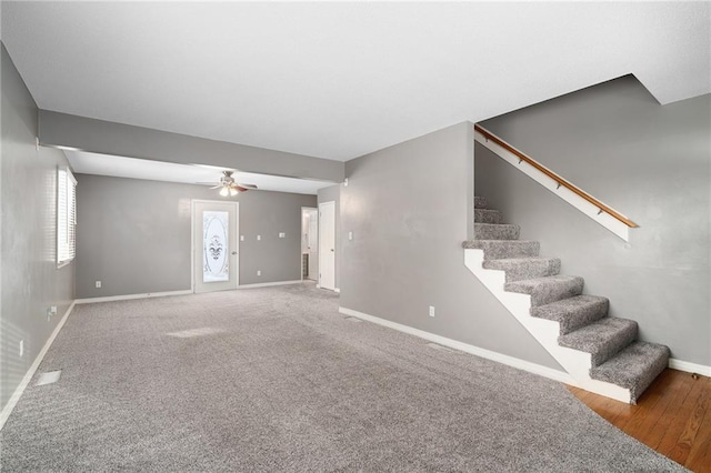 interior space with carpet floors and ceiling fan