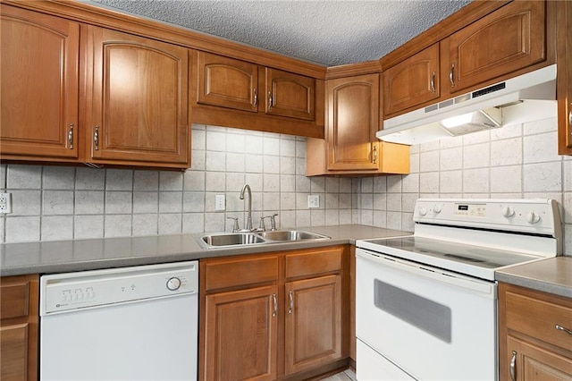 kitchen with tasteful backsplash, sink, a textured ceiling, and white appliances