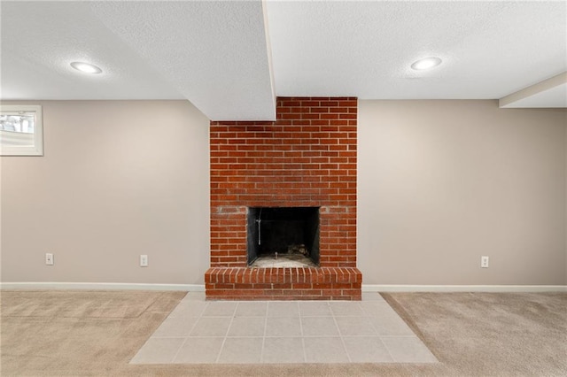 unfurnished living room with light carpet, a textured ceiling, and a fireplace