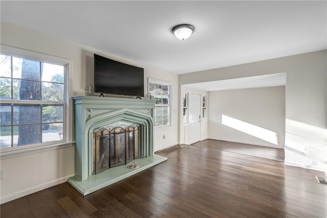 unfurnished living room featuring dark hardwood / wood-style flooring