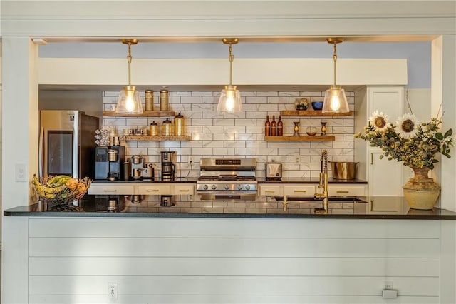 bar with sink, backsplash, stainless steel stove, and pendant lighting