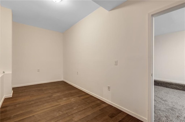 empty room with dark hardwood / wood-style flooring