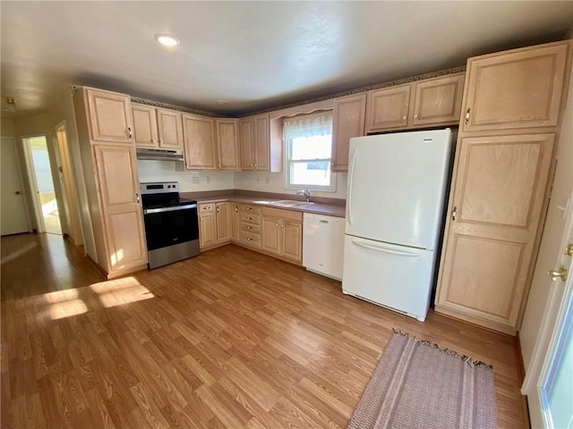 kitchen with light wood-type flooring, sink, light brown cabinetry, and white appliances