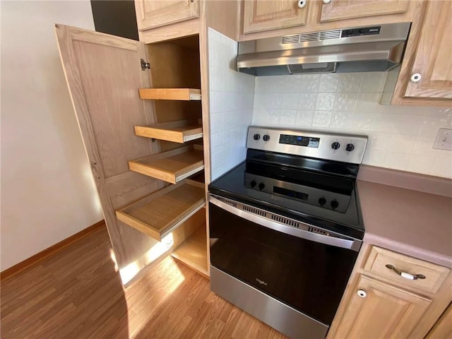 kitchen with electric stove, light wood-type flooring, light brown cabinets, and tasteful backsplash