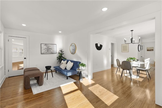 interior space featuring a notable chandelier and hardwood / wood-style flooring