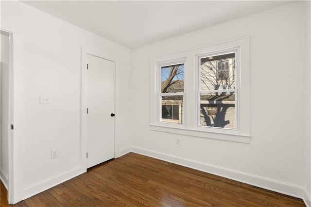 unfurnished bedroom featuring dark wood-type flooring