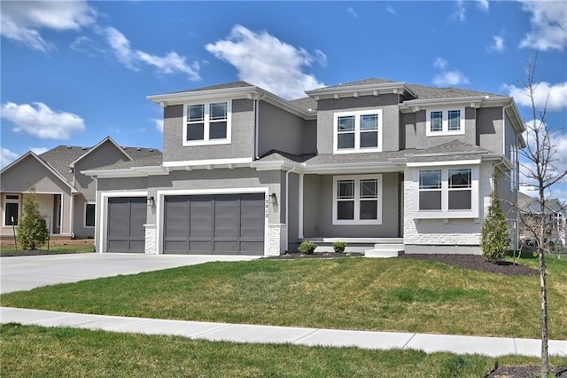 prairie-style home with a garage and a front lawn