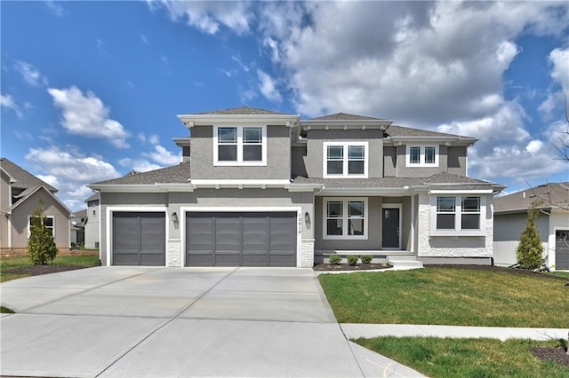 prairie-style home with a garage and a front lawn