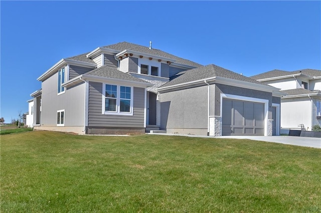 view of front of home featuring a front lawn and a garage