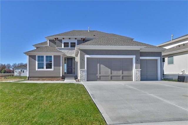 view of front facade featuring a front yard, a garage, and cooling unit